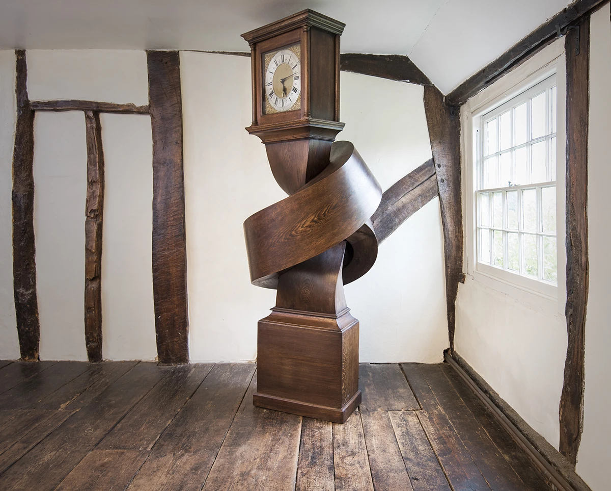 Growing up gets me down contorts a grandfather clock into an unlikely position
