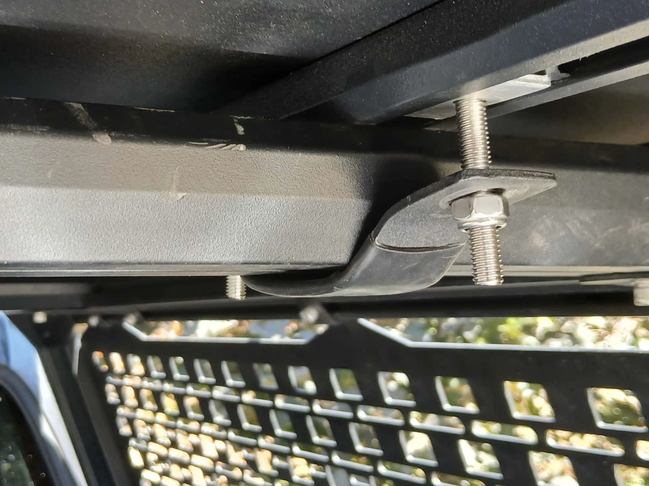 A look at the T-bolt assembly inside the track on the underside of the tent and the anti-slip note tightened on the bracket