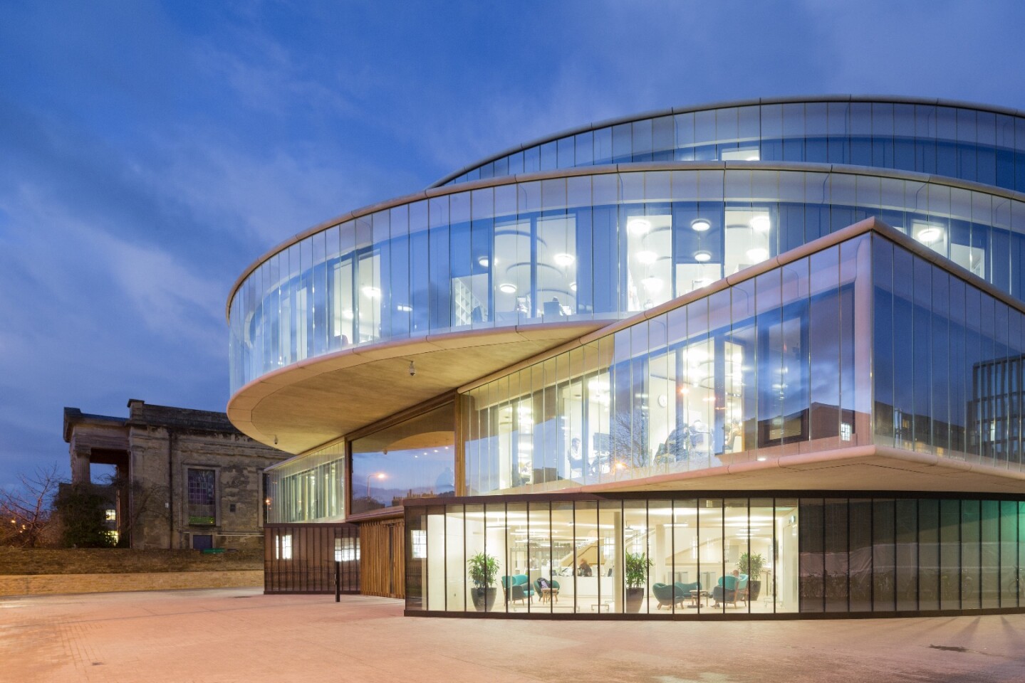 The Blavatnik School of Government by Herzog & de Meuron is a radical glazed building defined by its tiered shape and glazed facade