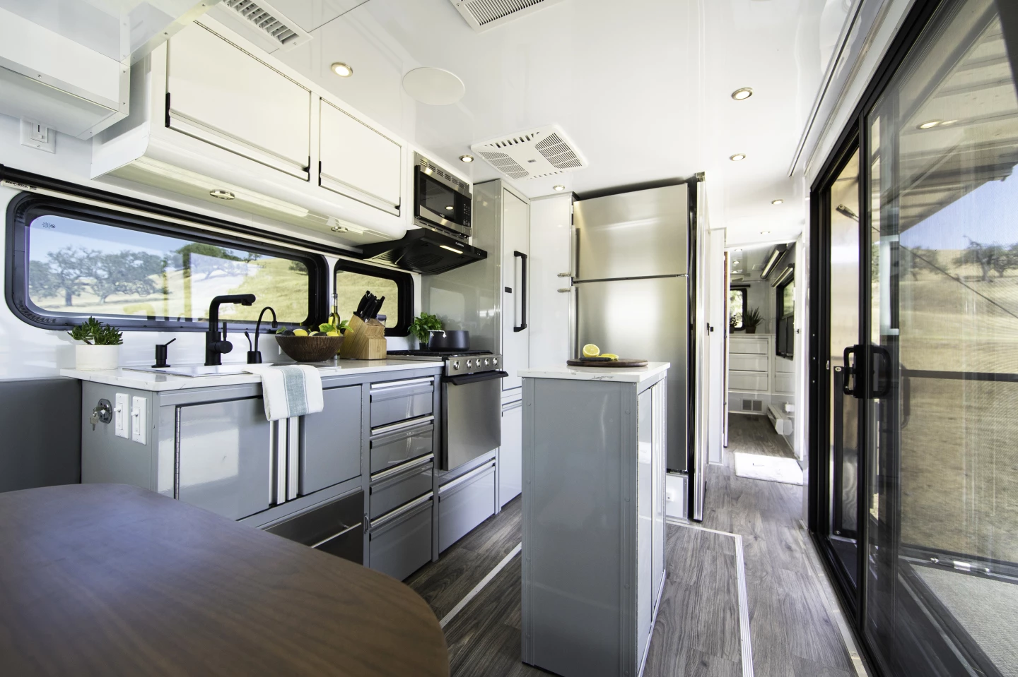 The Living Vehicle's kitchen comes equipped like a home kitchen, with standard and available features like a full-size fridge, range with oven, dishwasher and microwave