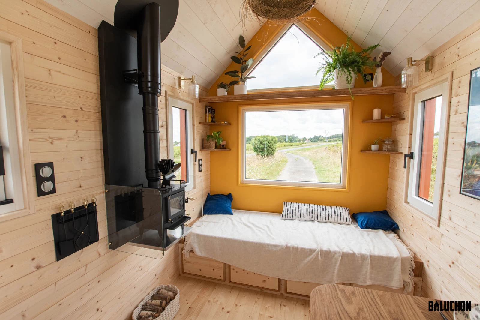 The living room in Leïla's tiny house includes a daybed with integrated storage