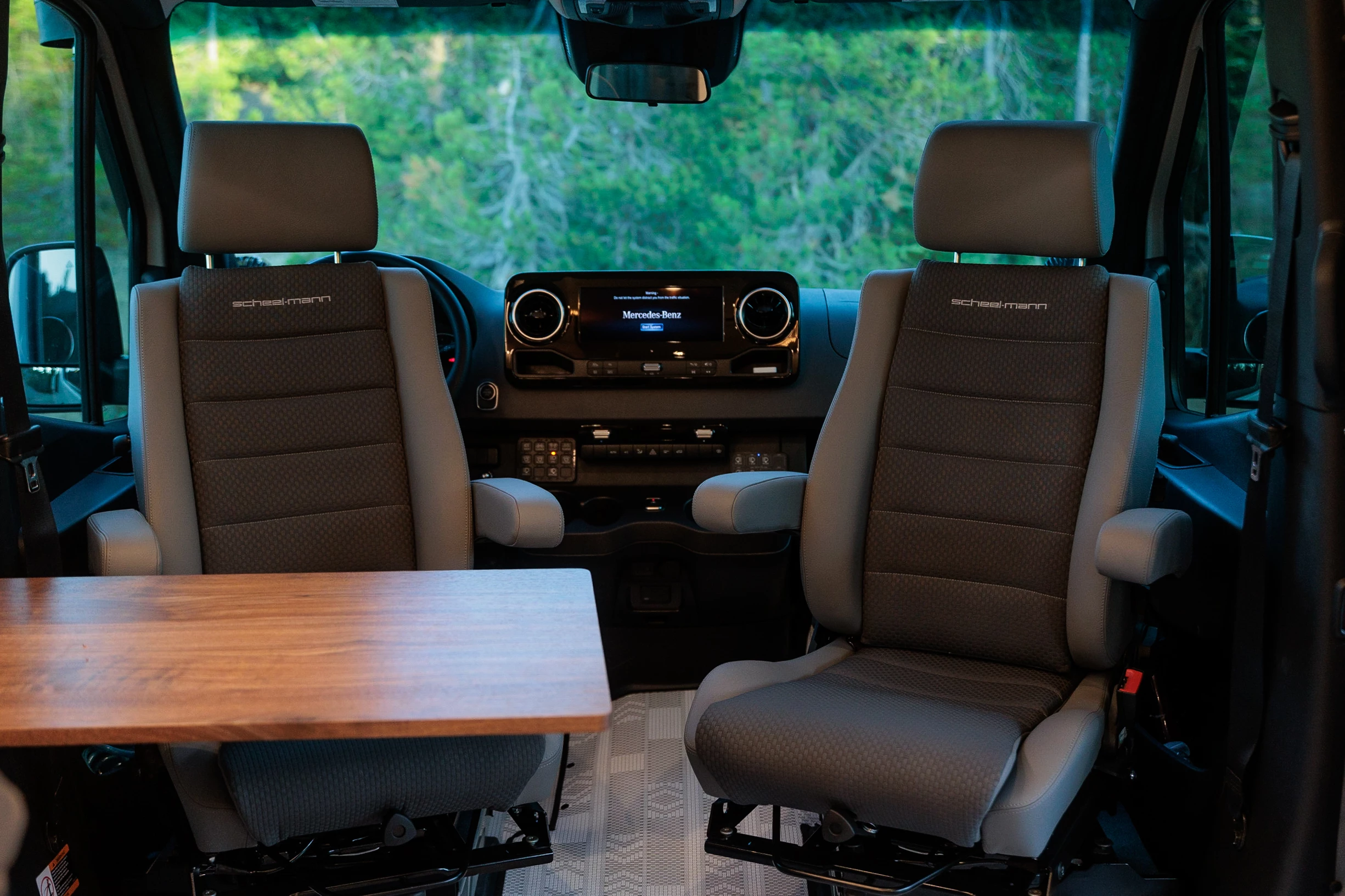 Benchmark replaces the stock seats with Scheel-Mann cab seats that swivel around