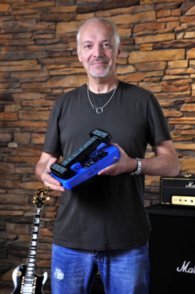 Peter Frampton holding his signature model Megawah effects pedal, which offers four different wah effects in addition to volume and presence control and "better than true bypass" circuitry