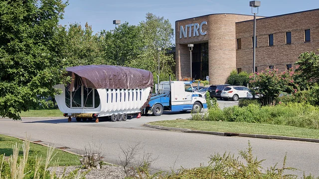 The AMIE building getting delivered to campus
