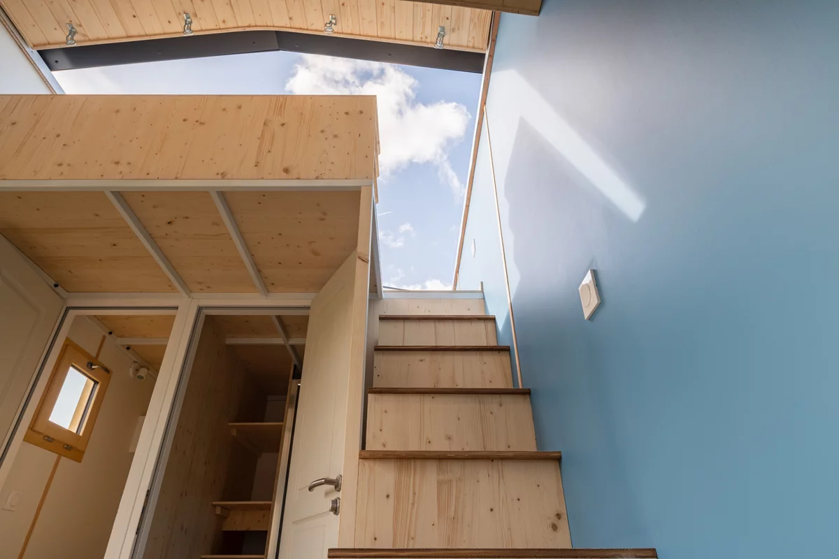 The Tiny d'Alexane's loft bedroom is reached by a staircase