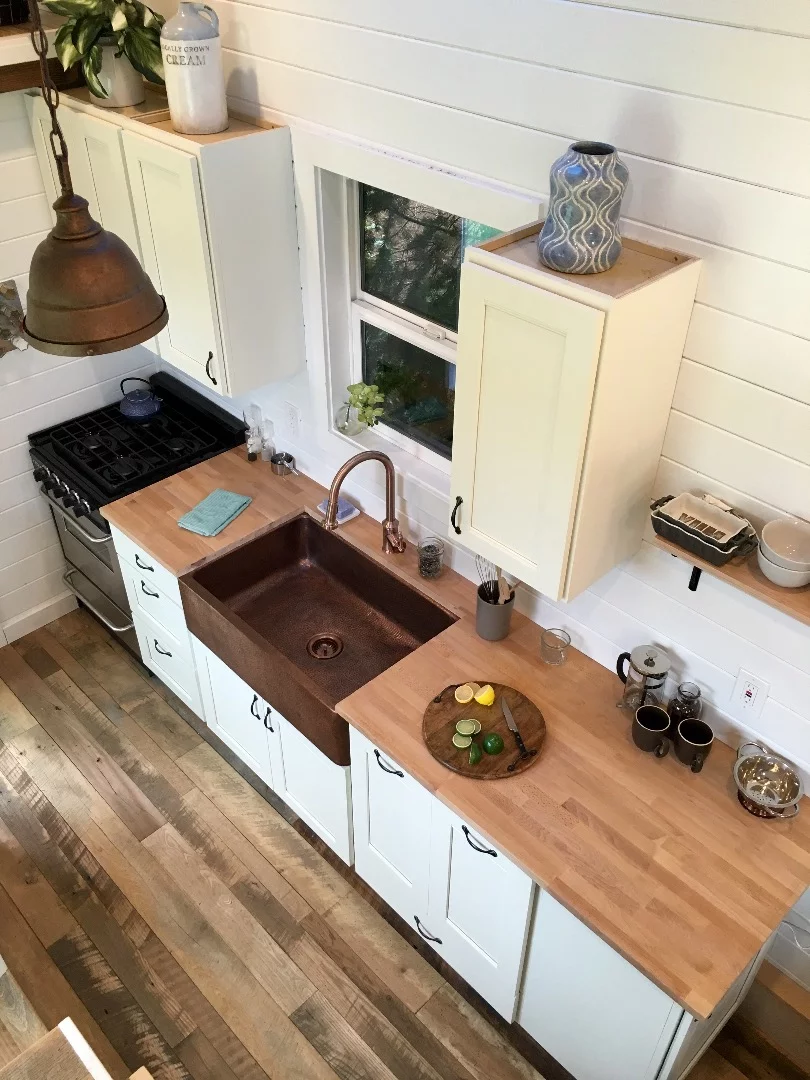 The kitchen in the Rocky Mountain Tiny Home features a copper sink