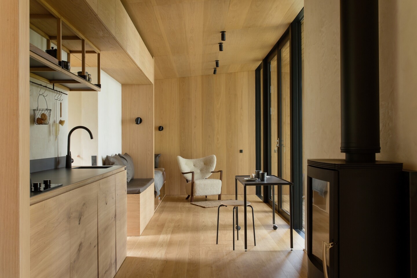 The interior of the Conga off-grid cabin is finished with wooden oak veneer panels