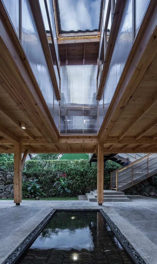 The Mountain House in Mist is centered around a patio area with a rain-fed water feature