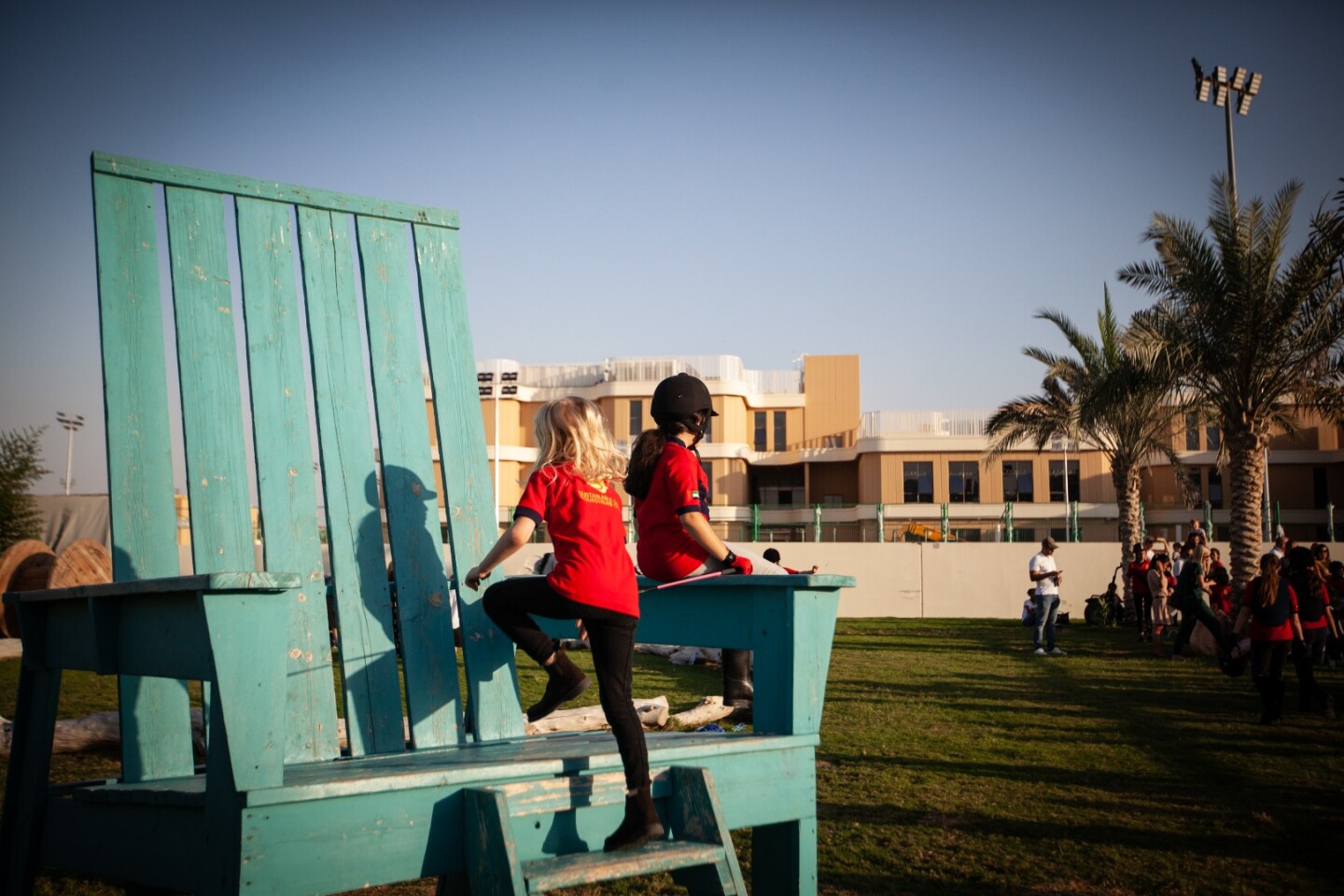 Children play near the equestrian center at the Dubai Sustainable City