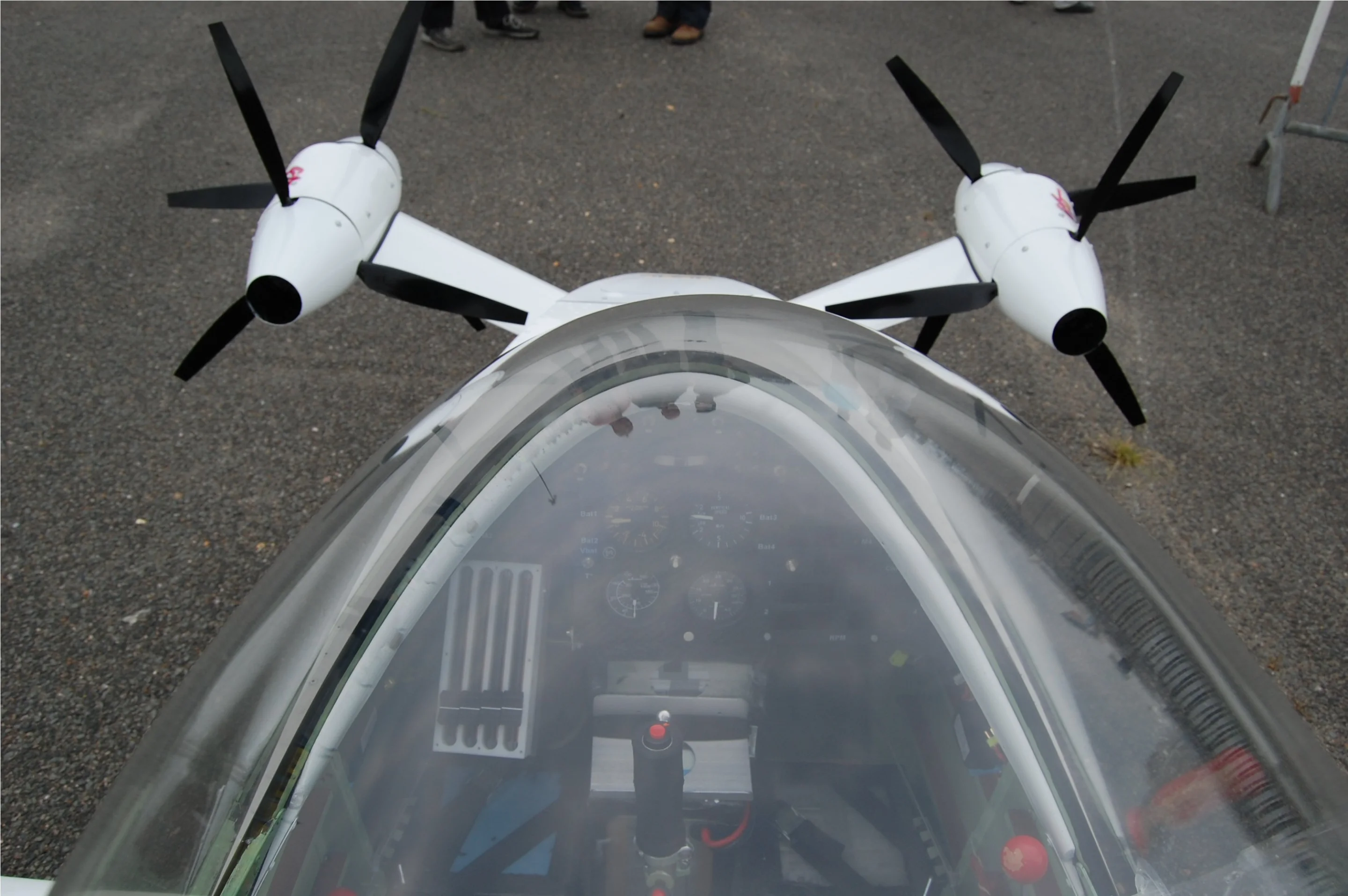 Over the top, showing the pilot compartment and the four electric engines each driving its own prop