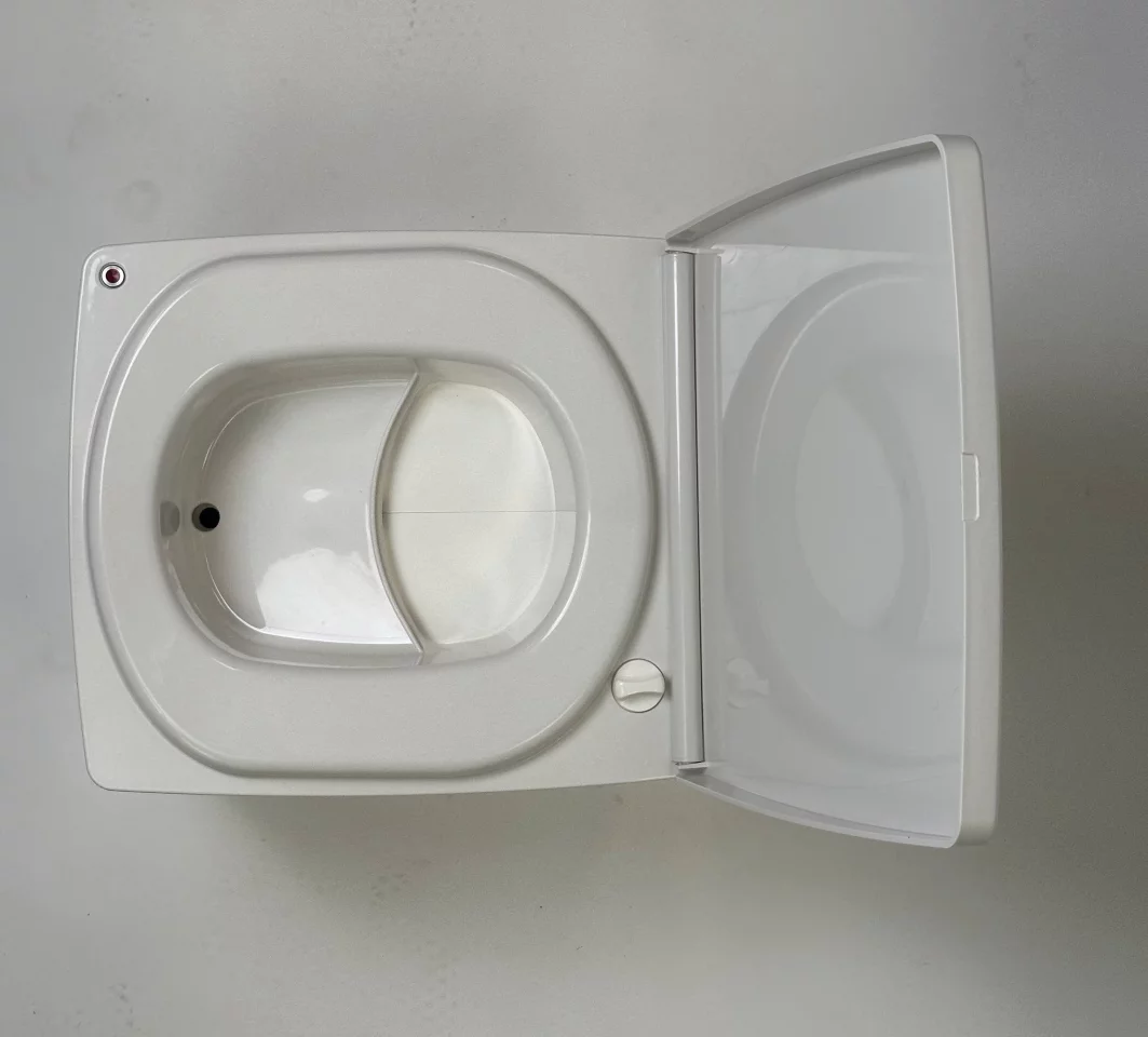 Pee gets diverted down into the drain to the bottle, while solids drop to the rear, where they're dumped into a waiting bag at the push of a button