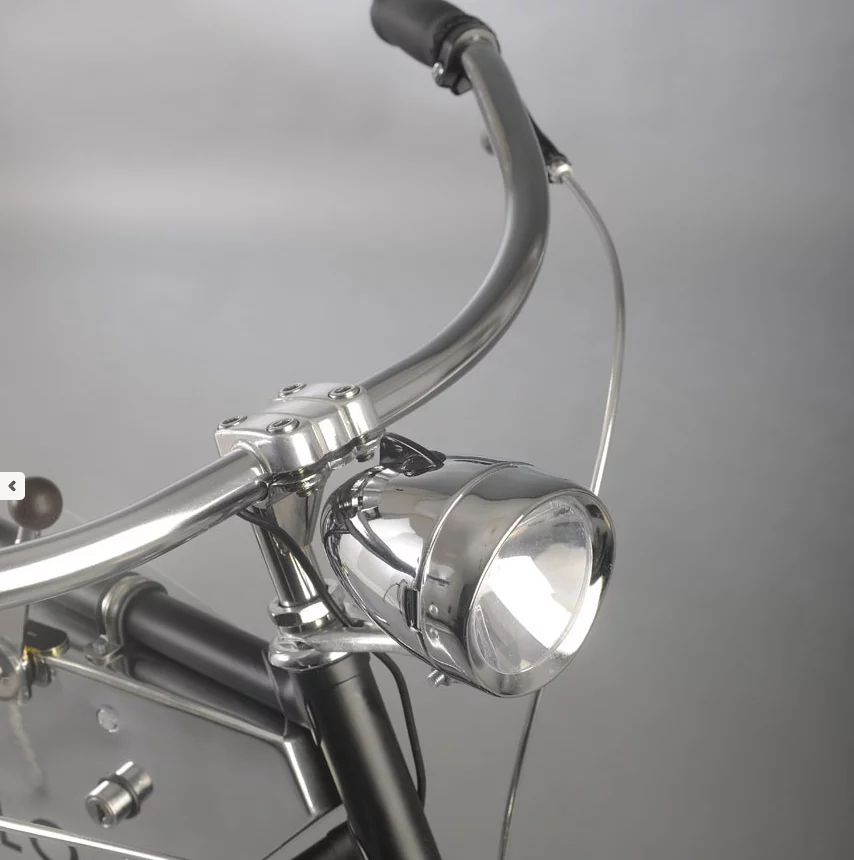 Curved handlebars and a large headlamp