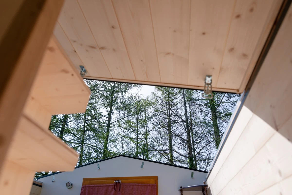 The Tiny House Franck's bedroom opens up to the elements like a car sunroof