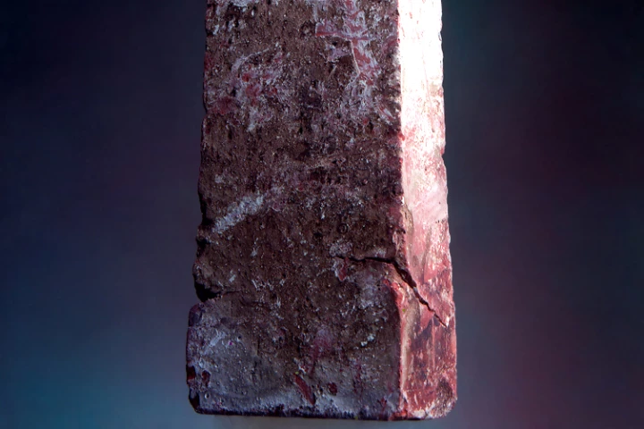 A 2.5 kg brick is supported by a piece of aerogel with a mass of only 2 grams