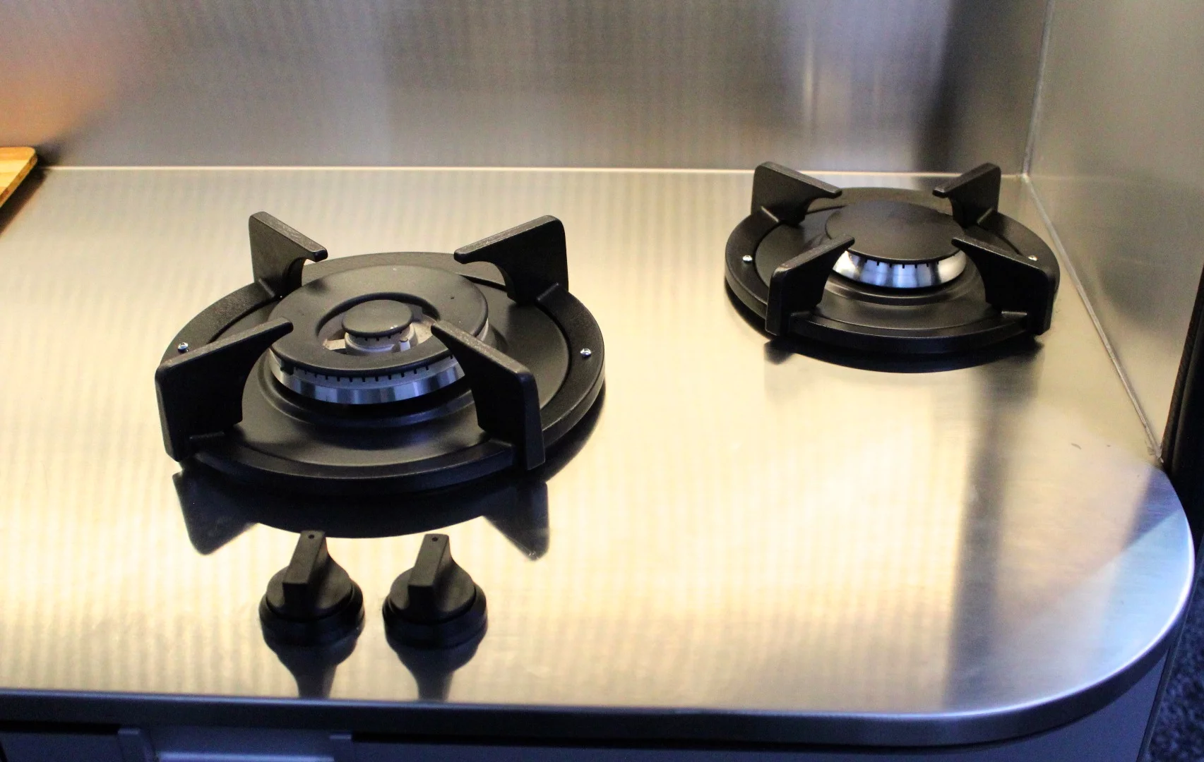 Lower-level Lume Travelers feature more traditional side-by-side dual-burner stoves, but the flagship model has independent PITT burners