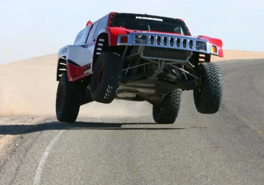 The spectacular Hummer of Robbie Gordon pulls a wheelstand