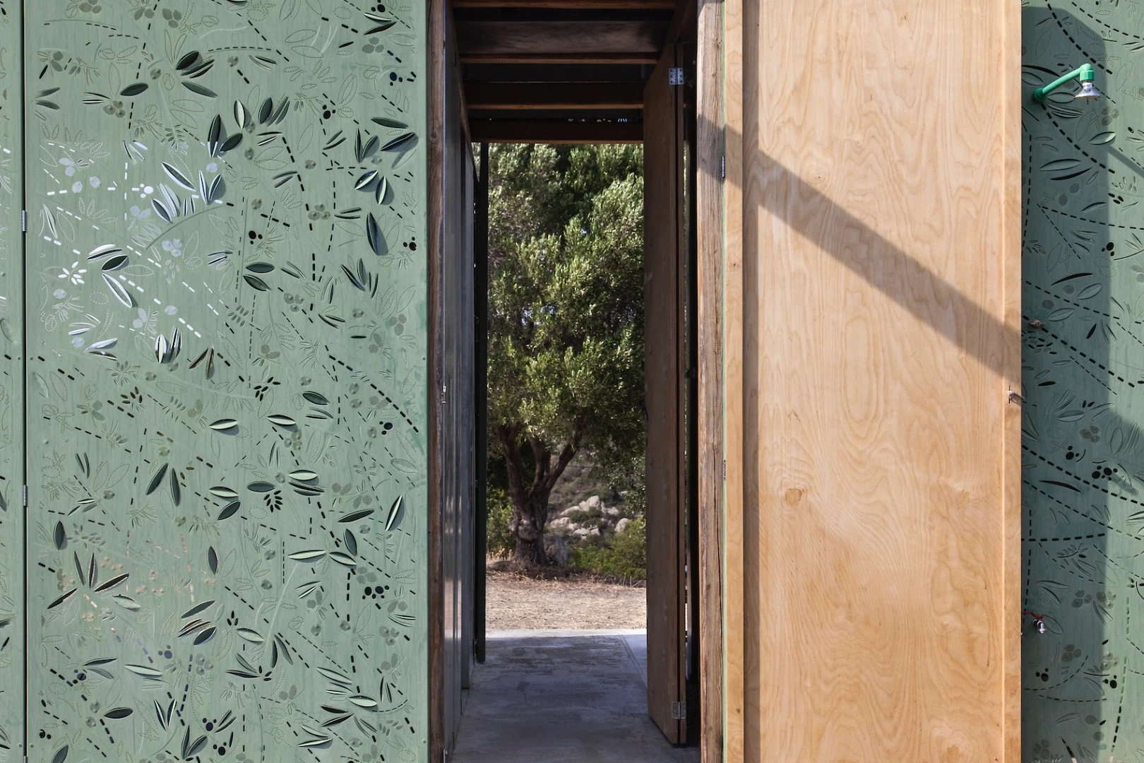 The inspiration behind the Olive Tree House's unusual metal cladding derives from its location next to an olive grove