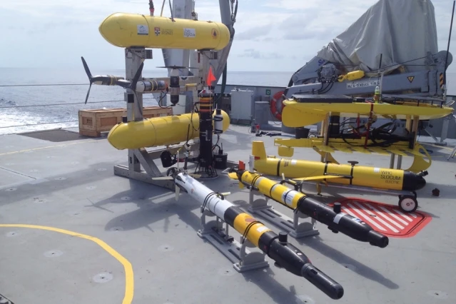 Several classes of autonomous underwater vehicles await deployment, off the coast of western Australia (Photo: MIT)