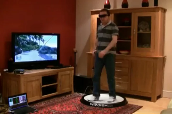 WizDish in action: in front of a television set accommodating a gamer wearing a VR headset