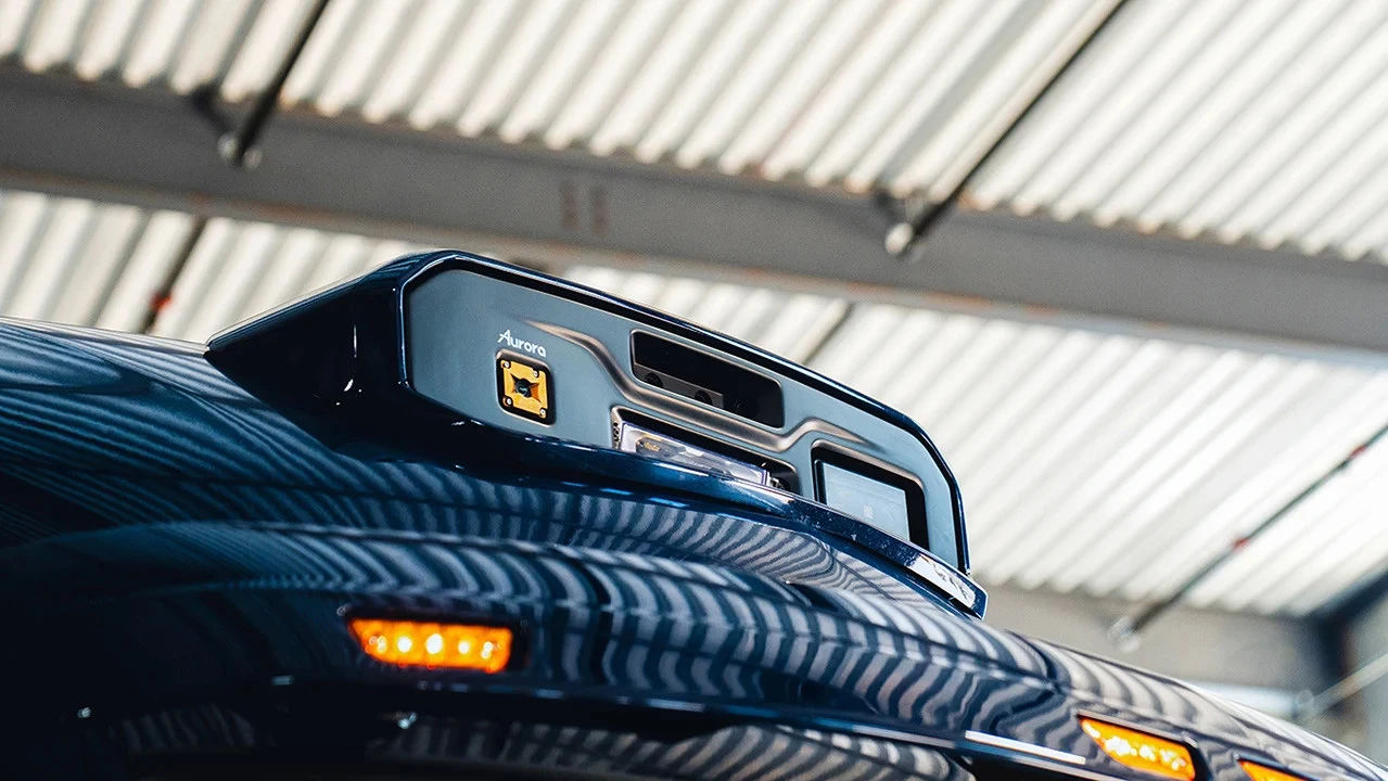 The Aurora Driver system includes more than two dozen LiDAR, radar, and camera components (like the ones seen at the top of this cabin) for safe self-driving
