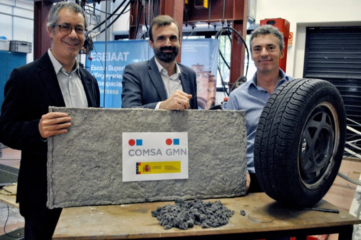 Researchers with a sheet of the tire fiber material
