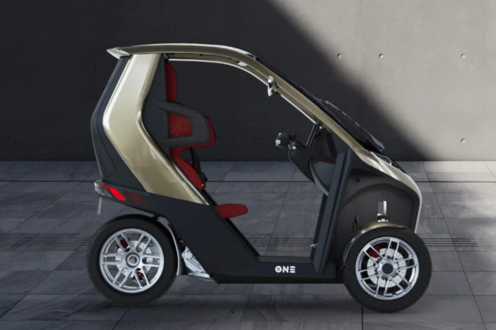 The One gets three wheels and a protective safety cell, which means you can safely (and lawfully) operate the vehicle without a helmet