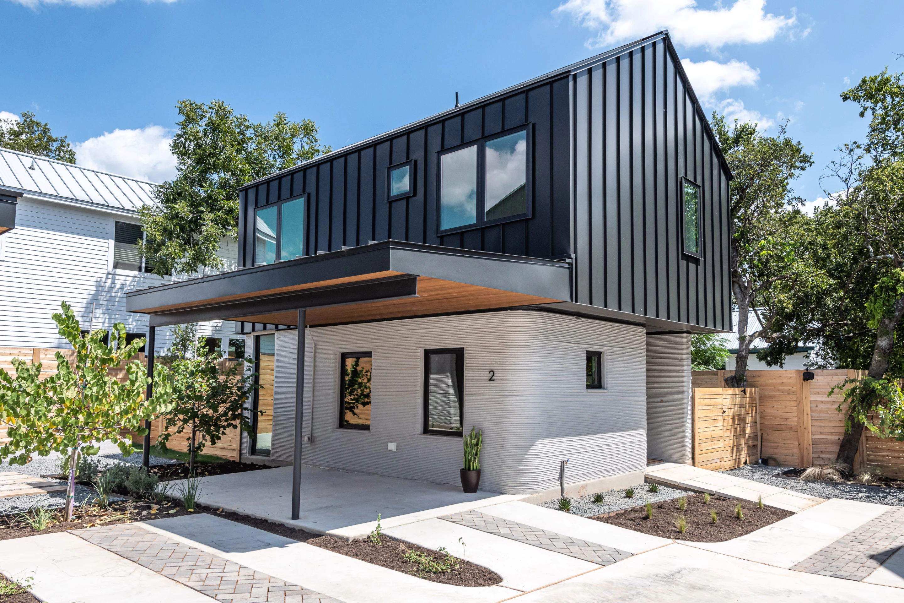 The East 17th St 3D-printed Home Development's homes include covered porch areas outside
