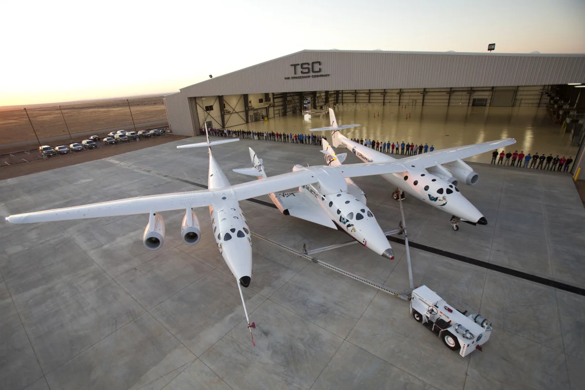 WhiteKnightTwo with SpaceShipTwo spaceplane docked outside the SpaceShip company's hangar FAITH in the Mojave Desert
