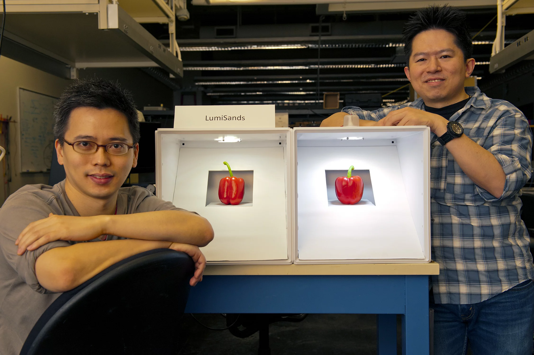LumiSands founders Chang-Ching Tu (left) and Ji Hoo, demonstrating the warmer hue of an LED bulb utilizing their technology