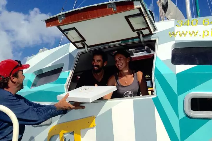 Sasha and Tara Bouis have transformed an abandoned aluminum sailboat into a floating pizza shop