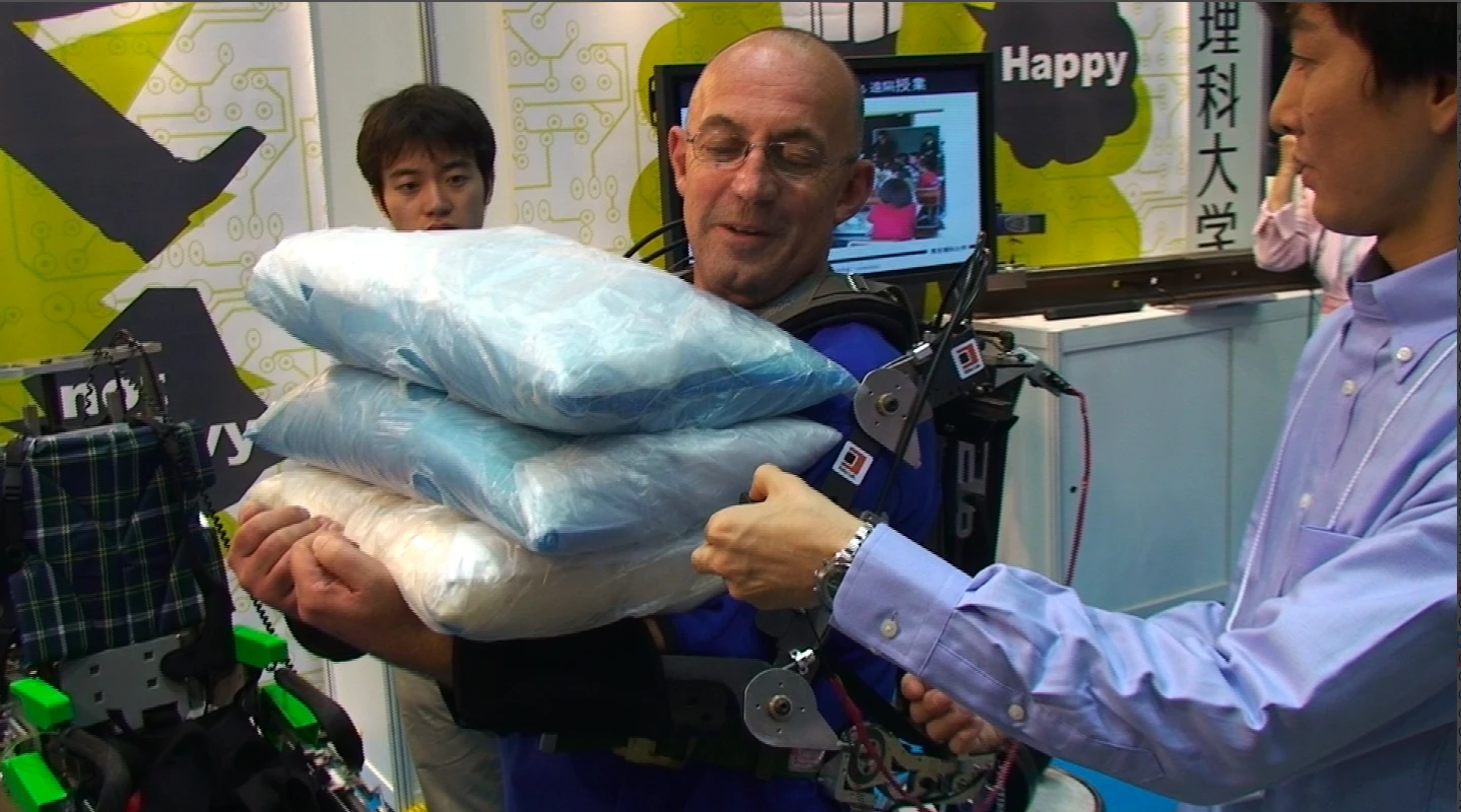 Author Mike Hanlon tries out a Koba Labs' prototype exoskeleton. "You'd be surprised how much you can hold in your arms when it's turned on", says Hanlon