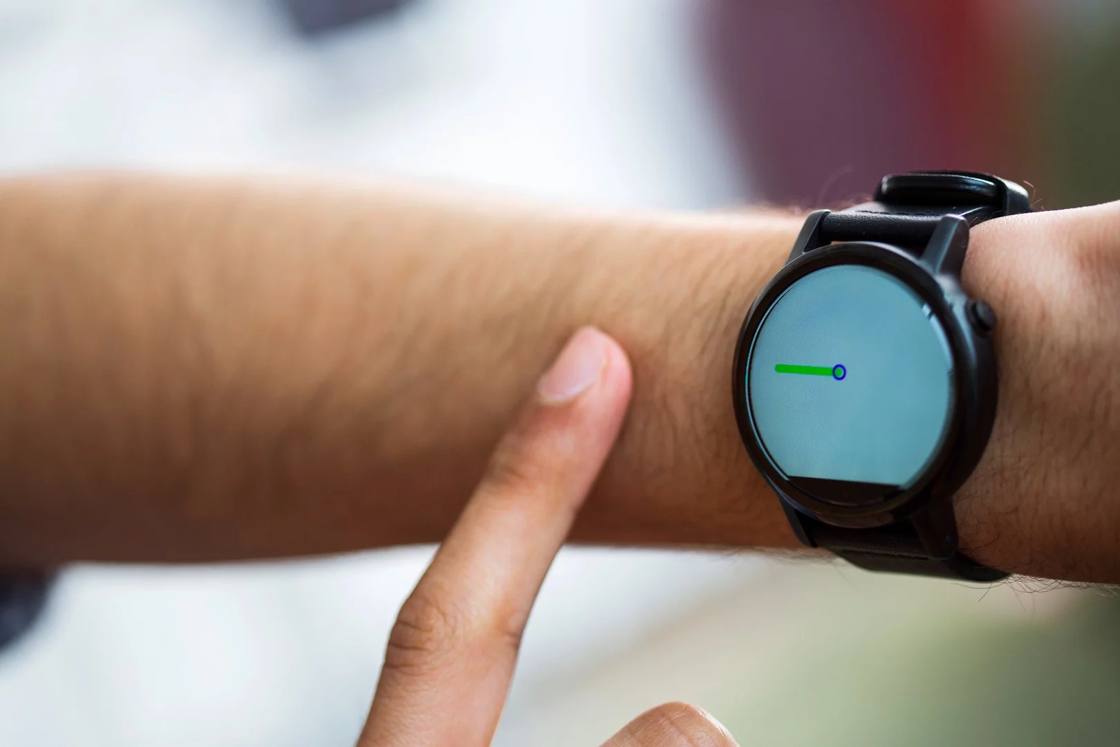 A FingerIO-equipped smartwatch tracks a user's finger as it draws a line on their arm