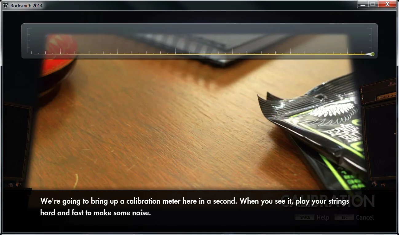Instrument calibration involves strumming all six strings loudly and then muting when prompted