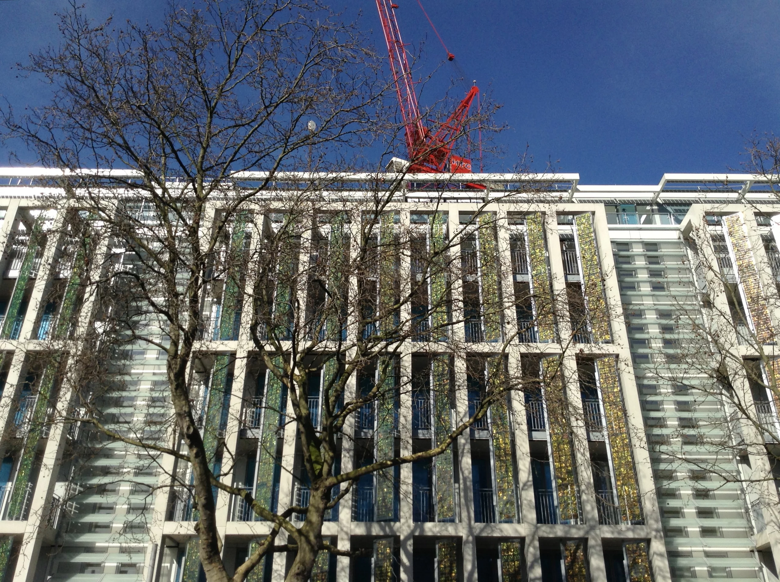Kingsgate House under construction in Chelsea, London with gold solar shutters at the windows (Photo: Horden Cherry Lee Architects)