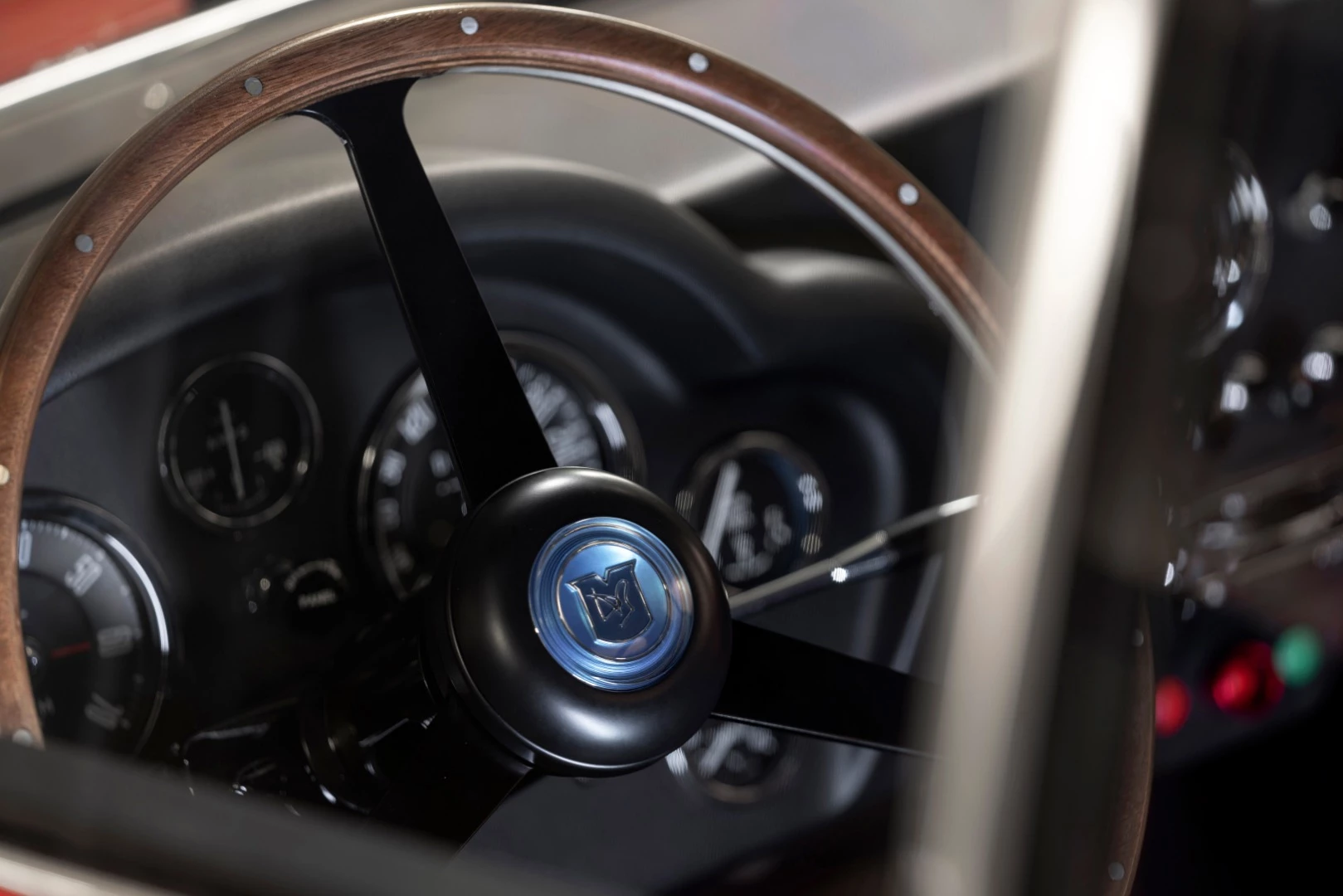 Period-inspired continuation specification instrumentation and interior equipment such as a full FIA-approved roll cage are standard