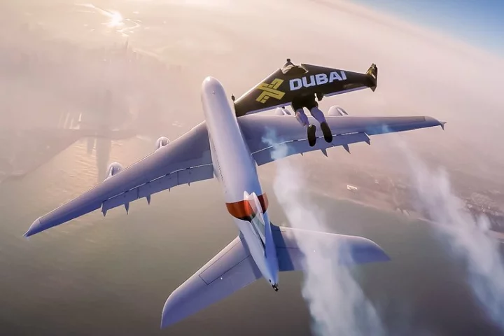 Jetman flies above an Airbus A380 passenger jet in Dubai