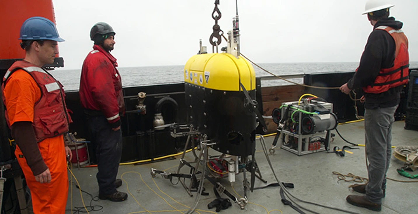 Engineers from Woods Hole Oceanographic Institution and ship’s crew on the R/V Rachel Carson prepare to launch the Mesobot into Monterey Bay