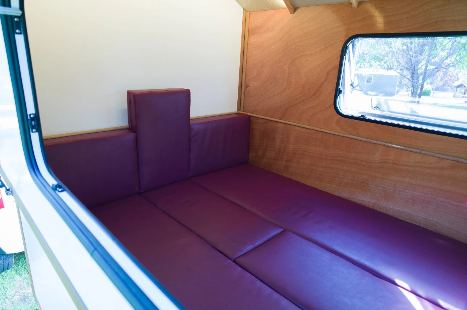 The seat backs fill out the middle to create the double bed option