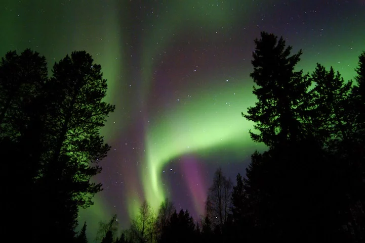 The night time light display of Aurora Borealis is caused by the collision of gaseous particles from the earth's atmosphere, with charged particles released from the sun's atmosphere (image from Hotel Kakslauttanen)
