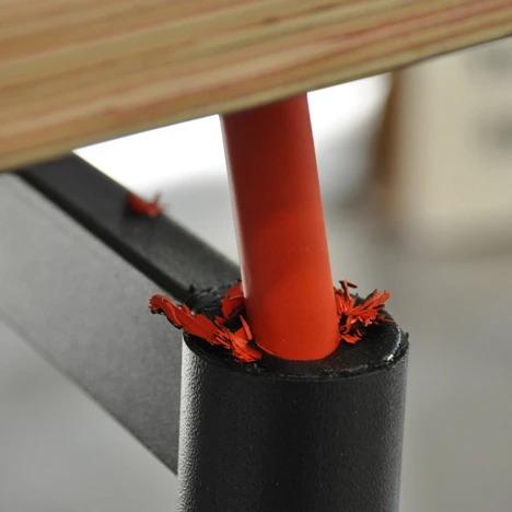 Each corner of the school desk is outfitted with collapsible "crush zones" that distribute the brunt of an impact to the edges, rather than the middle