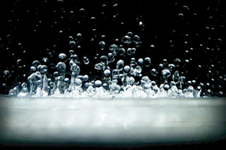 Close up of the dancing liquid within the transparent tube