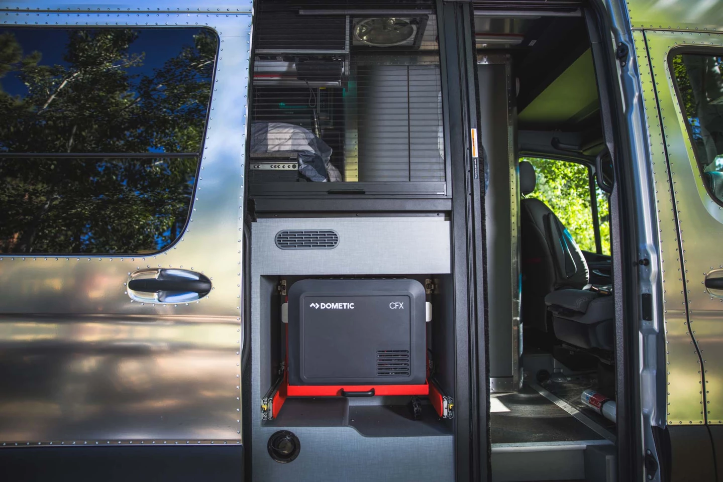A secret passage in the kitchen allows the Dometic CFX3 fridge to slide in or out for quick access; it also removes to carry around camp, though you might need to power it with an external battery or generator