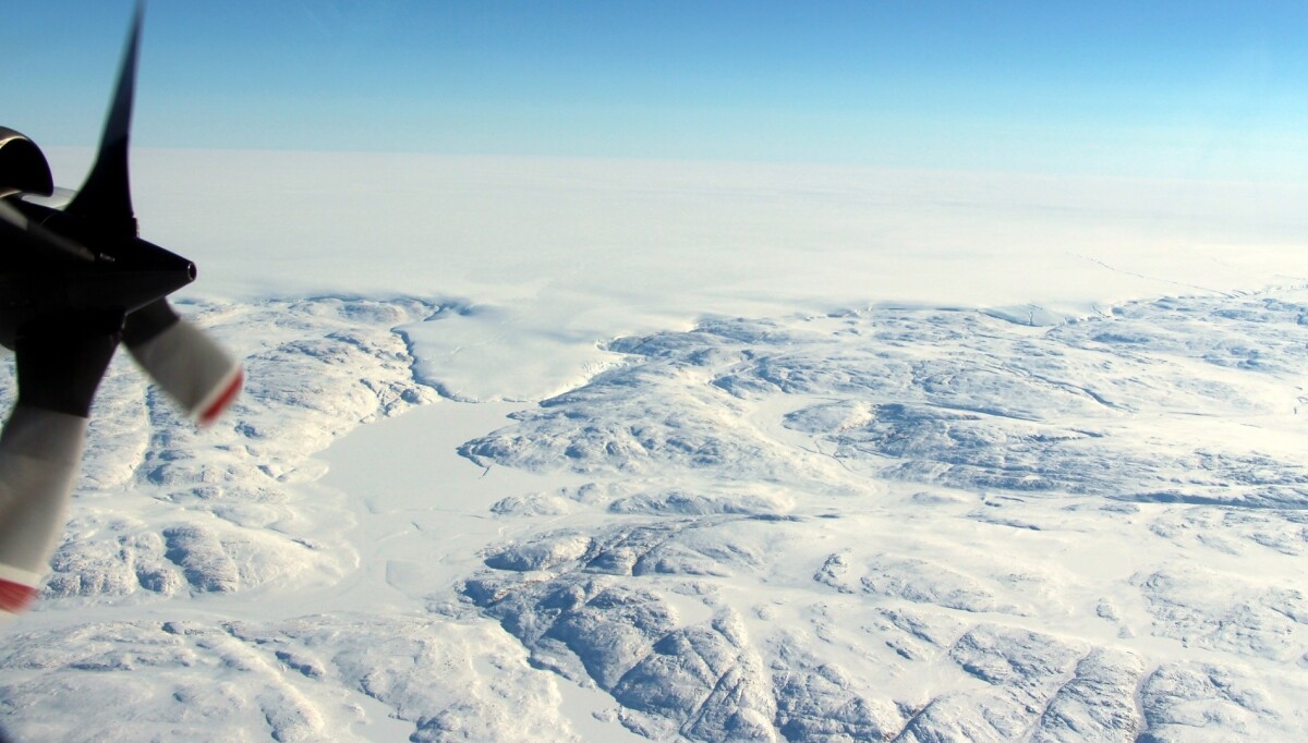 The Hiawatha impact crater is covered by the Greenland Ice Sheet, which flows just beyond the crater rim, forming a semi-circular edge