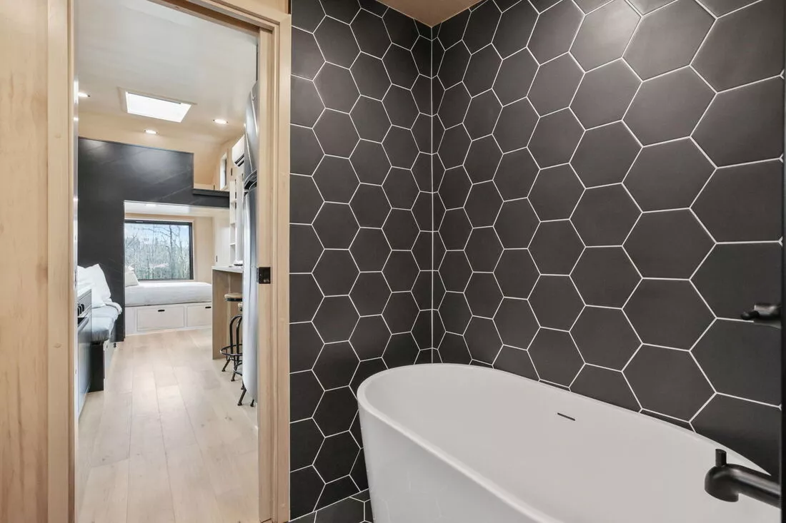 The Sangja's bathroom boasts a bathtub and shower, which is a relative rarity in a tiny house