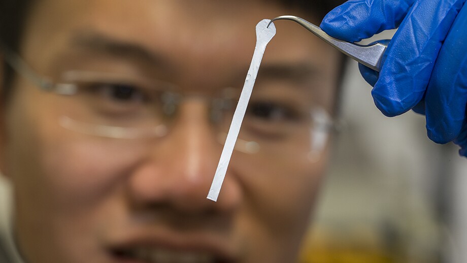 William Wong holds up a sample of the material, in its non-rolled state