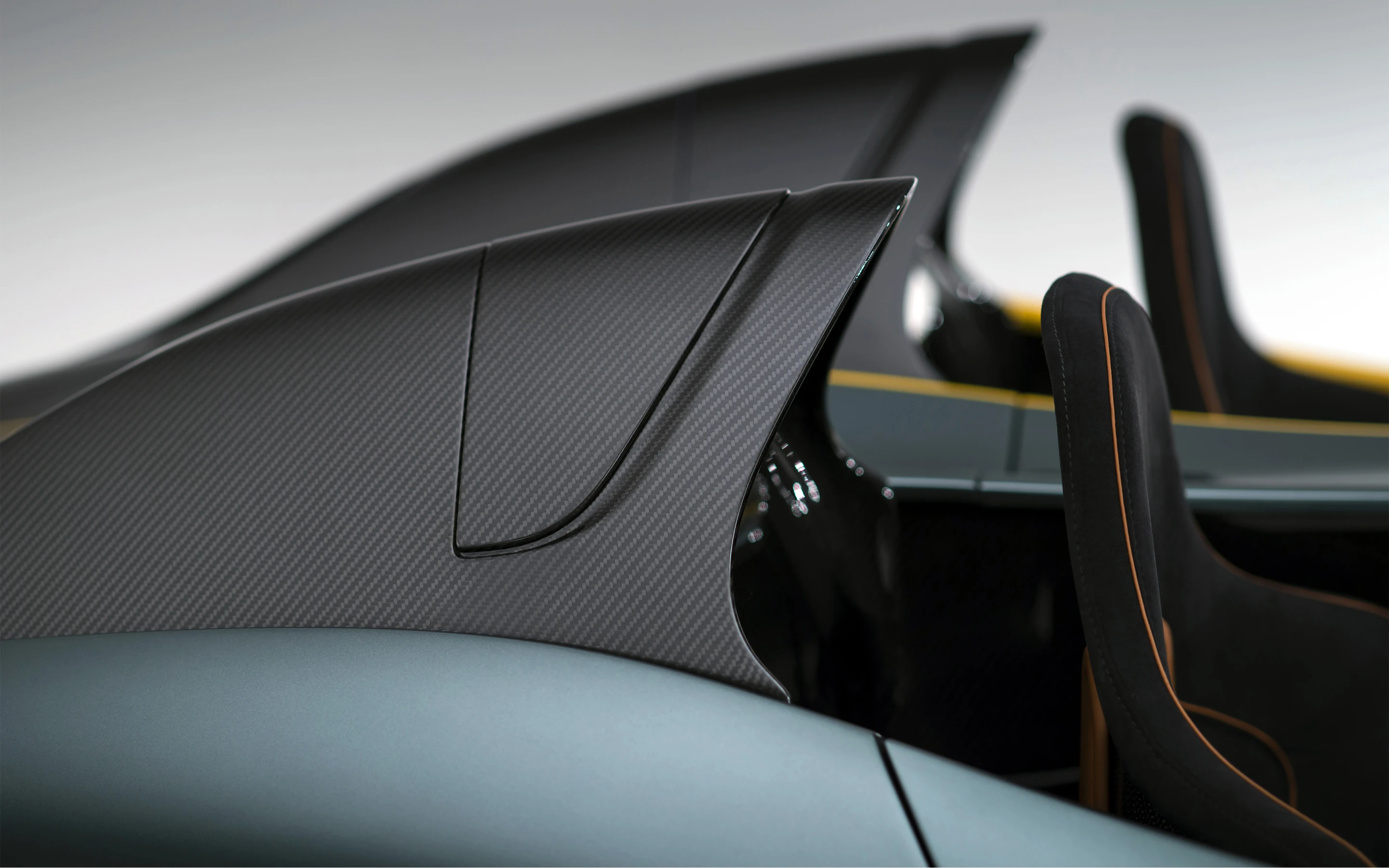 Twin cockpit fairings of carbon fiber keep occupants safe while also looking tastey