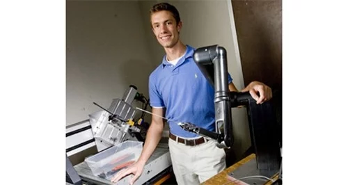 A. J. Rogers, one of the research team, and the shrapnel-finding surgical robot