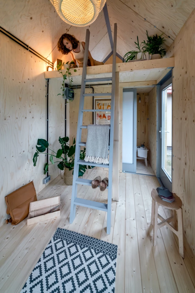 The Kabinka features a typical tiny house-style bedroom that's reached by ladder