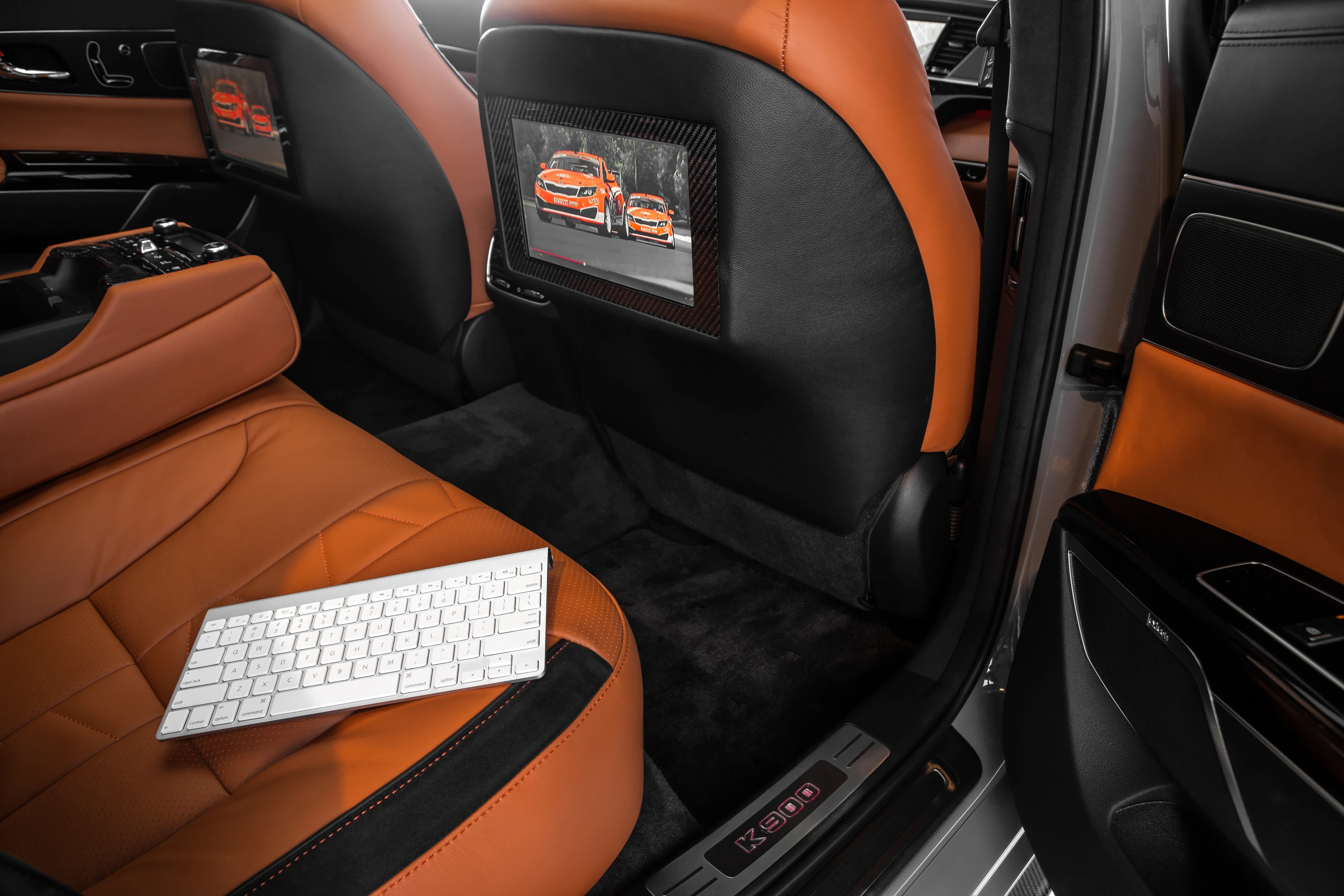 Rear seat passengers are treated to 11-inch monitors, which can play footage from iRacing.com