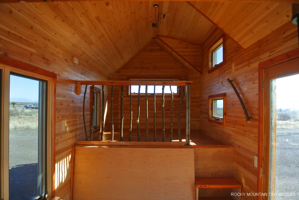 The bedroom area is located over the gooseneck (raised) area of the trailer and accessed by stairs (Photo: Rocky Mountain Tiny Houses)